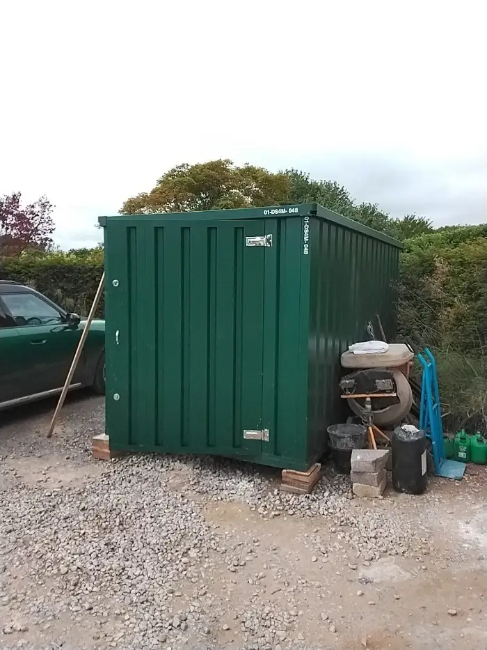 Door To Store unit on a gravel drive beside a garden