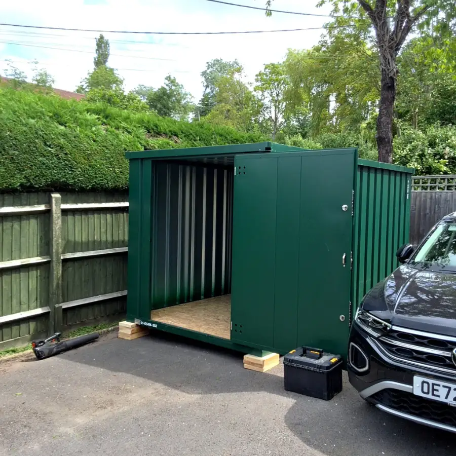Door To Store unit on a driveway next to a parked car